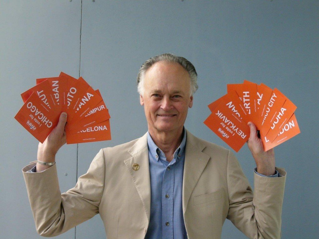 New7Wonders Founder-President Bernard Weber holds all the postcards.