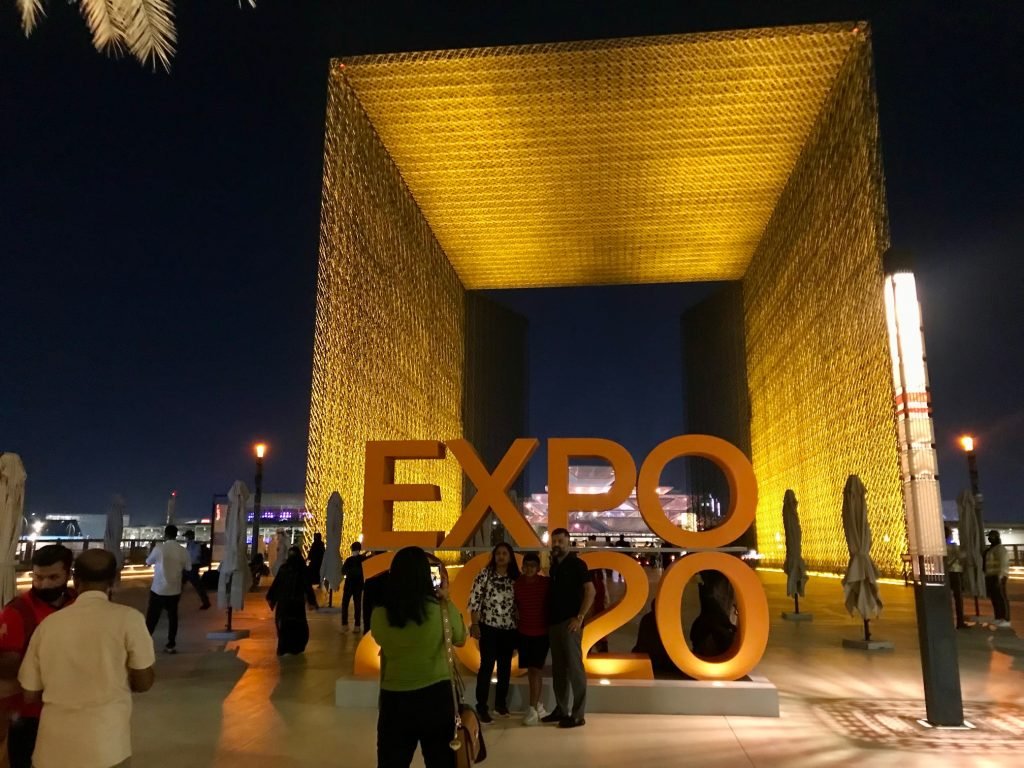 Visitors posing for a photo by the Expo 2020 Dubai sign