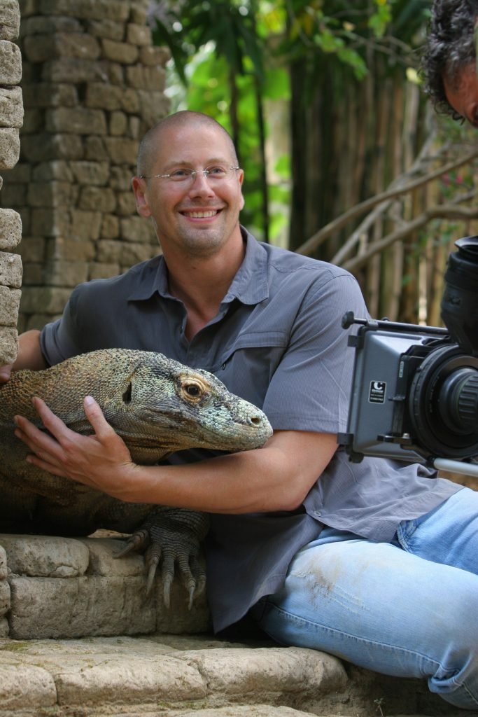 Professor Bryan Fry, with a young Komodo in his arms
